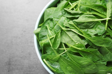 Fresh green healthy spinach on grey table, top view