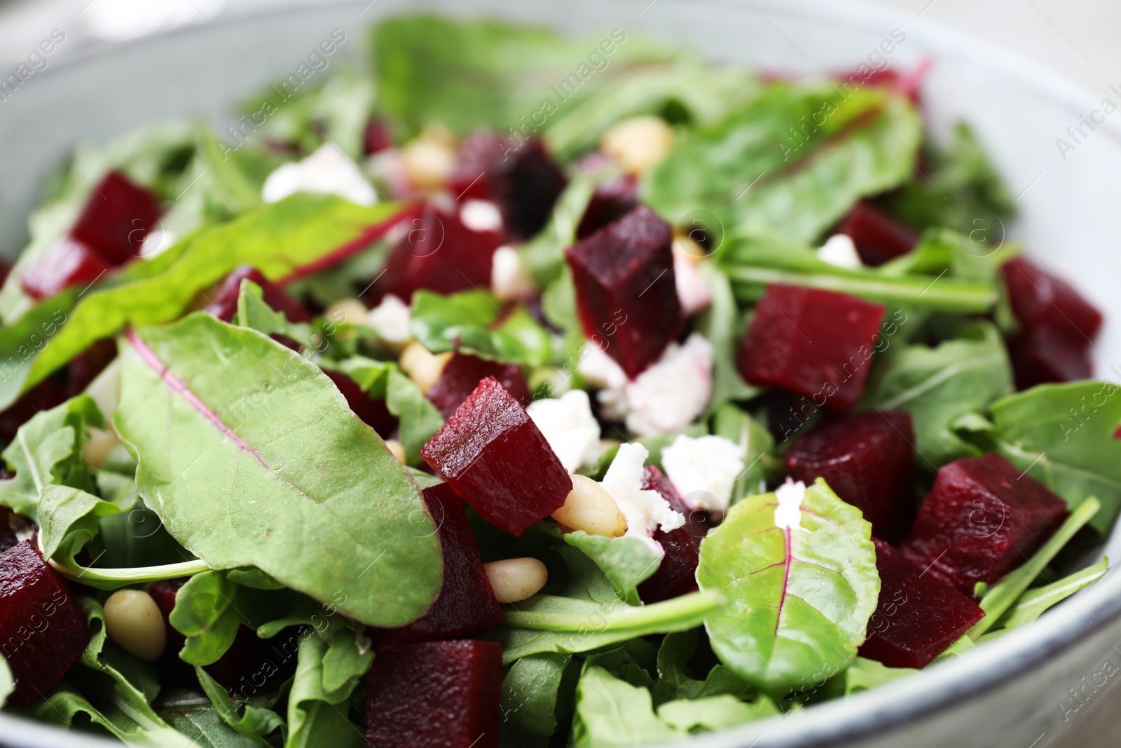 Photo of Delicious beet salad in bowl, closeup view