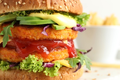 Vegan burger with carrot patties on blurred background, closeup