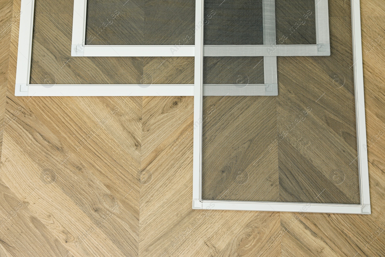 Photo of Set of window screens on wooden floor, flat lay. Space for text