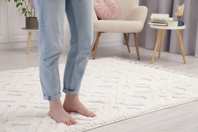 Photo of Woman standing on beige carpet in room, closeup. Space for text