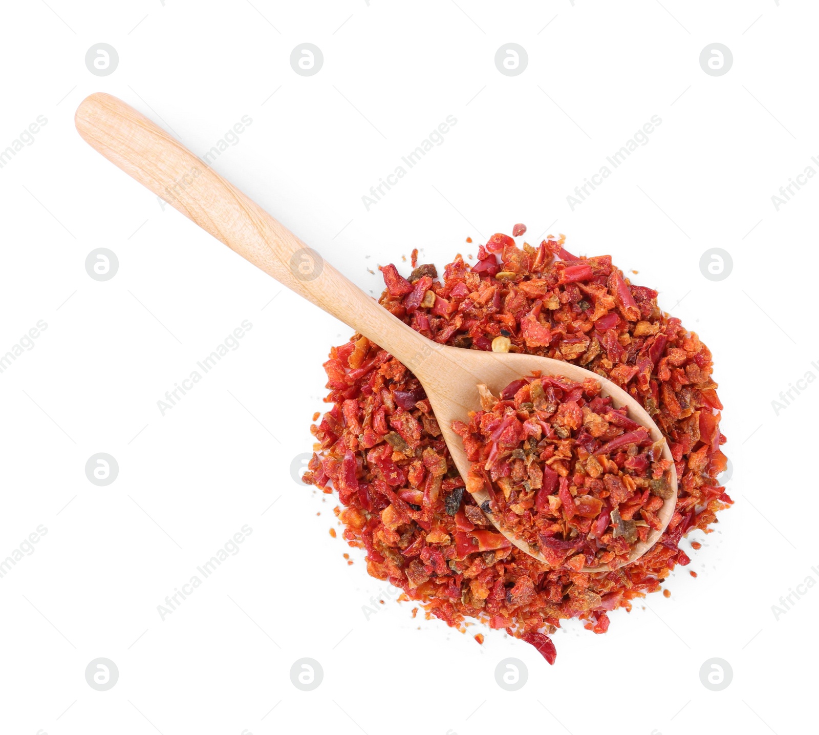 Photo of Aromatic spice. Red chili pepper flakes and spoon isolated on white, top view