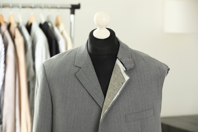 Photo of Mannequin with unfinished jacket in tailor shop