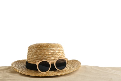 Photo of Composition with hat, beach sand and sunglasses on white background, space for text