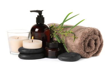 Beautiful spa composition with burning candles and different care products on white background
