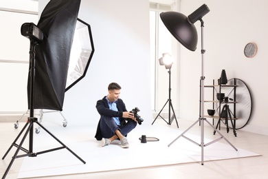 Young photographer working in professional studio