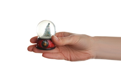 Photo of Woman holding beautiful snow globe on white background, closeup