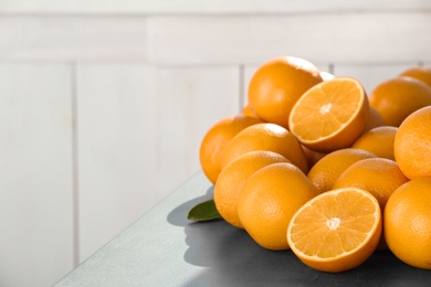 Photo of Fresh juicy oranges on table, space for text. Healthy fruits