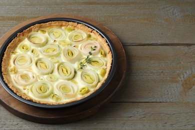 Photo of Tasty leek pie on wooden table. Space for text