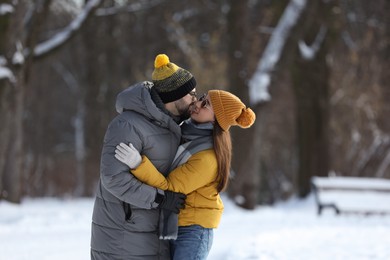 Beautiful happy couple outdoors on winter day. Space for text