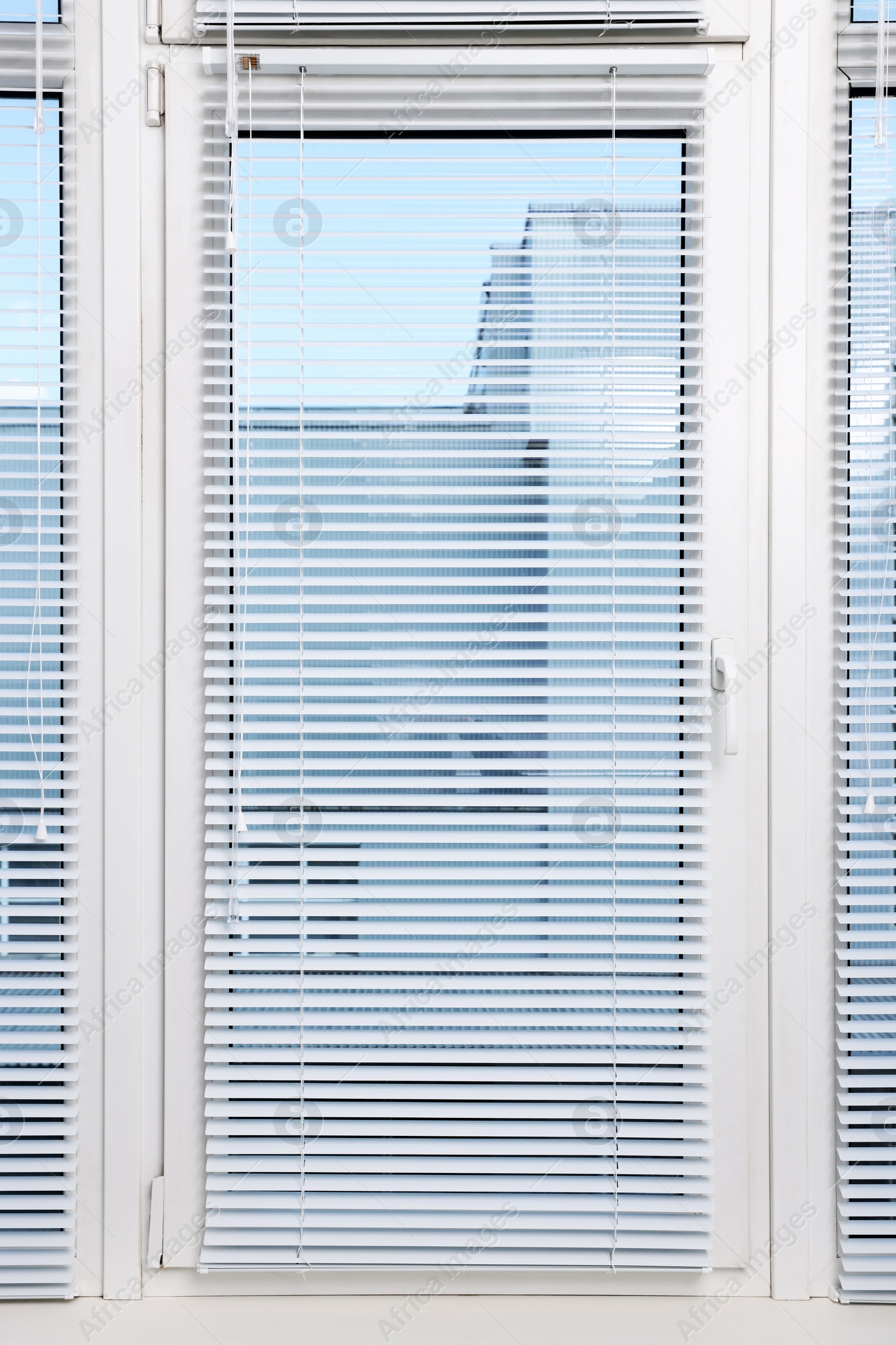 Photo of Window with horizontal blinds and white frame indoors