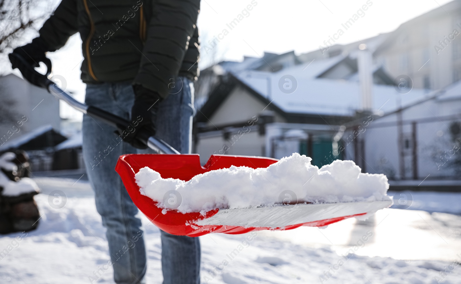 Photo of Person shoveling snow outdoors on winter day, closeup