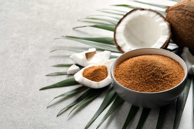 Photo of Composition with natural coconut sugar on grey table, space for text