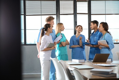 Group of smart medical students with gadgets in college