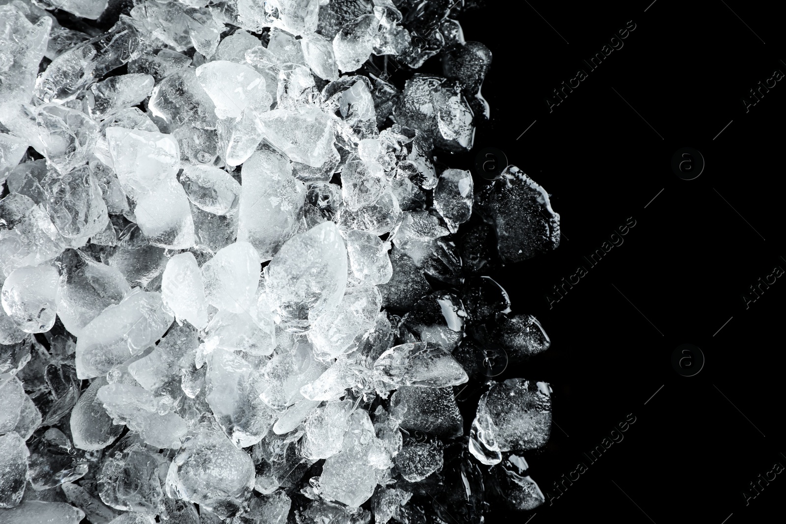 Photo of Heap of crushed ice on black table, top view