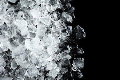 Photo of Heap of crushed ice on black table, top view