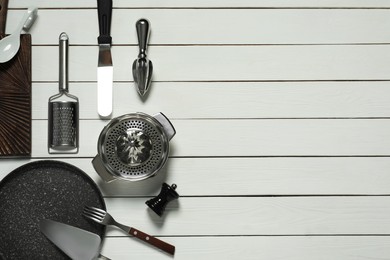 Photo of Set of different kitchen utensils on white wooden table, flat lay with space for text