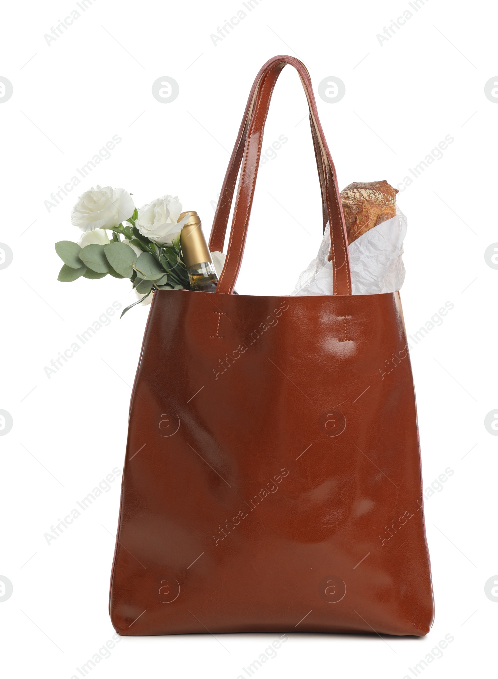 Photo of New leather shopper bag with purchases on white background
