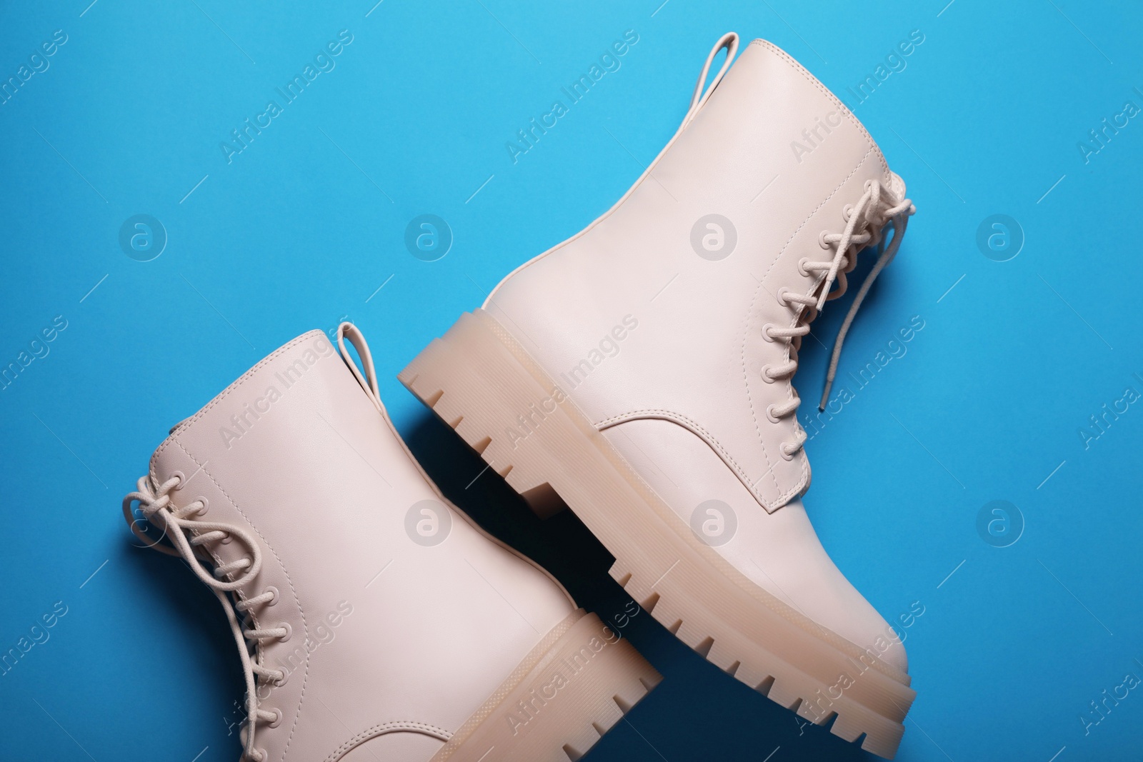 Photo of Pair of stylish leather shoes on light blue background, flat lay