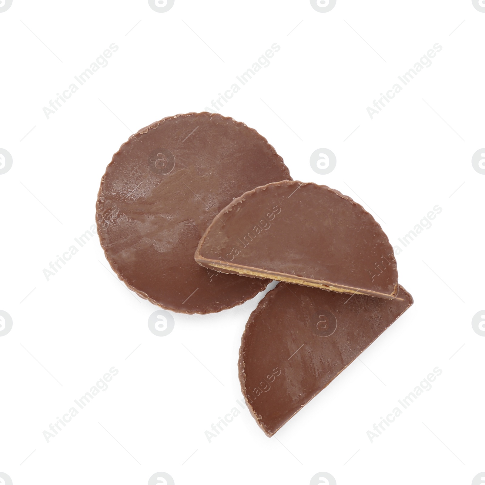 Photo of Cut and whole delicious peanut butter cups on white background, top view