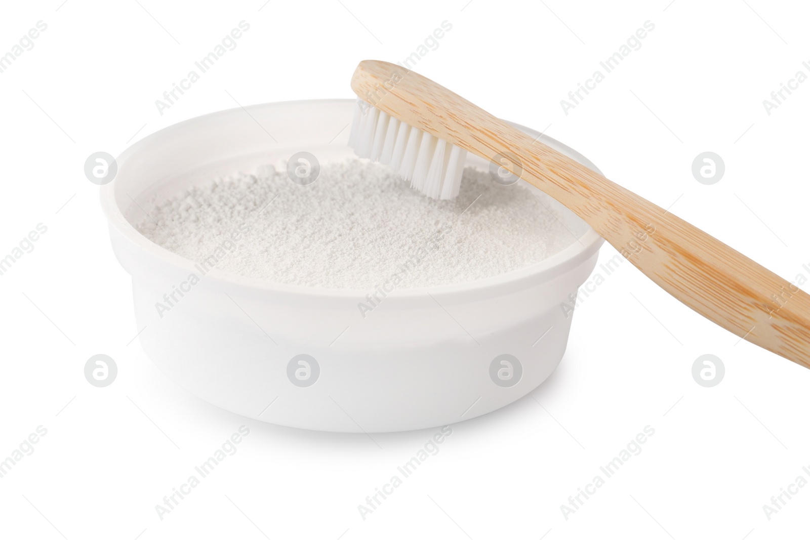 Photo of Bowl of tooth powder and brush on white background