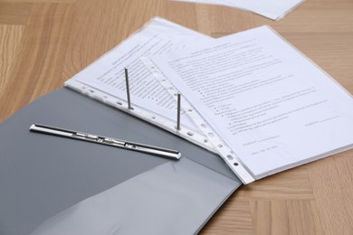 Photo of Folder with punched pockets on wooden table