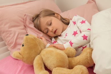 Photo of Little girl snoring while sleeping in bed