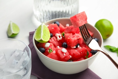 Photo of Delicious salad with watermelon, blueberries and cheese on white table, closeup