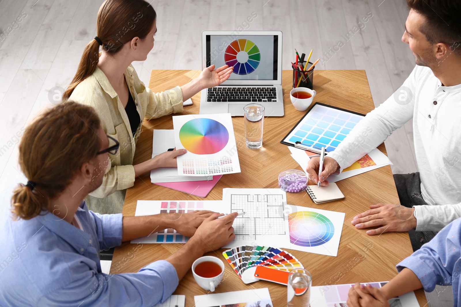 Photo of Professional team of interior designers working at table