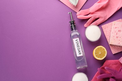 Photo of Eco friendly natural cleaners. Flat lay composition with bottle of vinegar on purple background, space for text