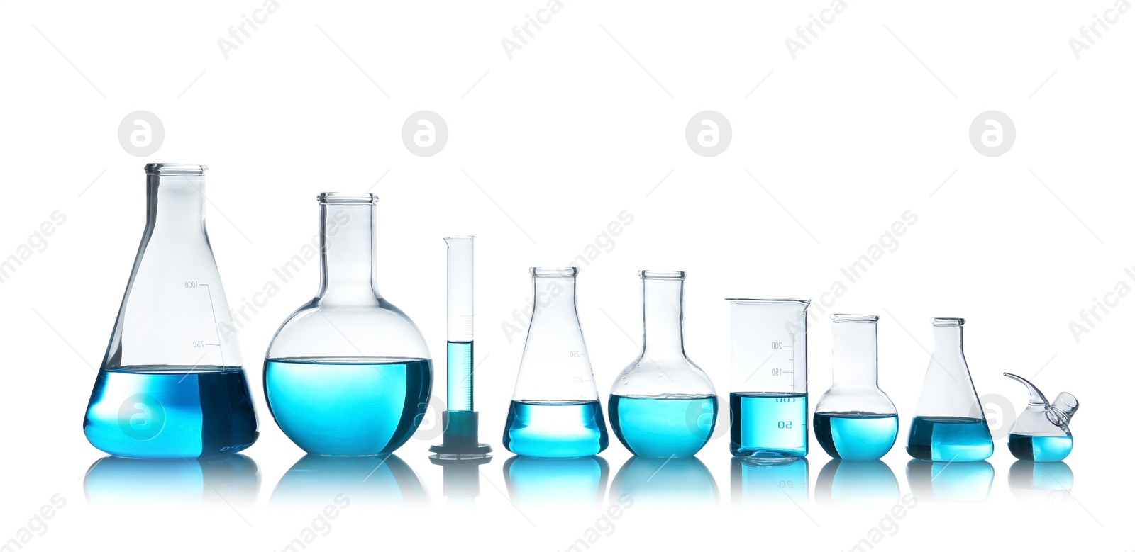 Photo of Laboratory glassware for chemical analysis with blue liquid on table against white background