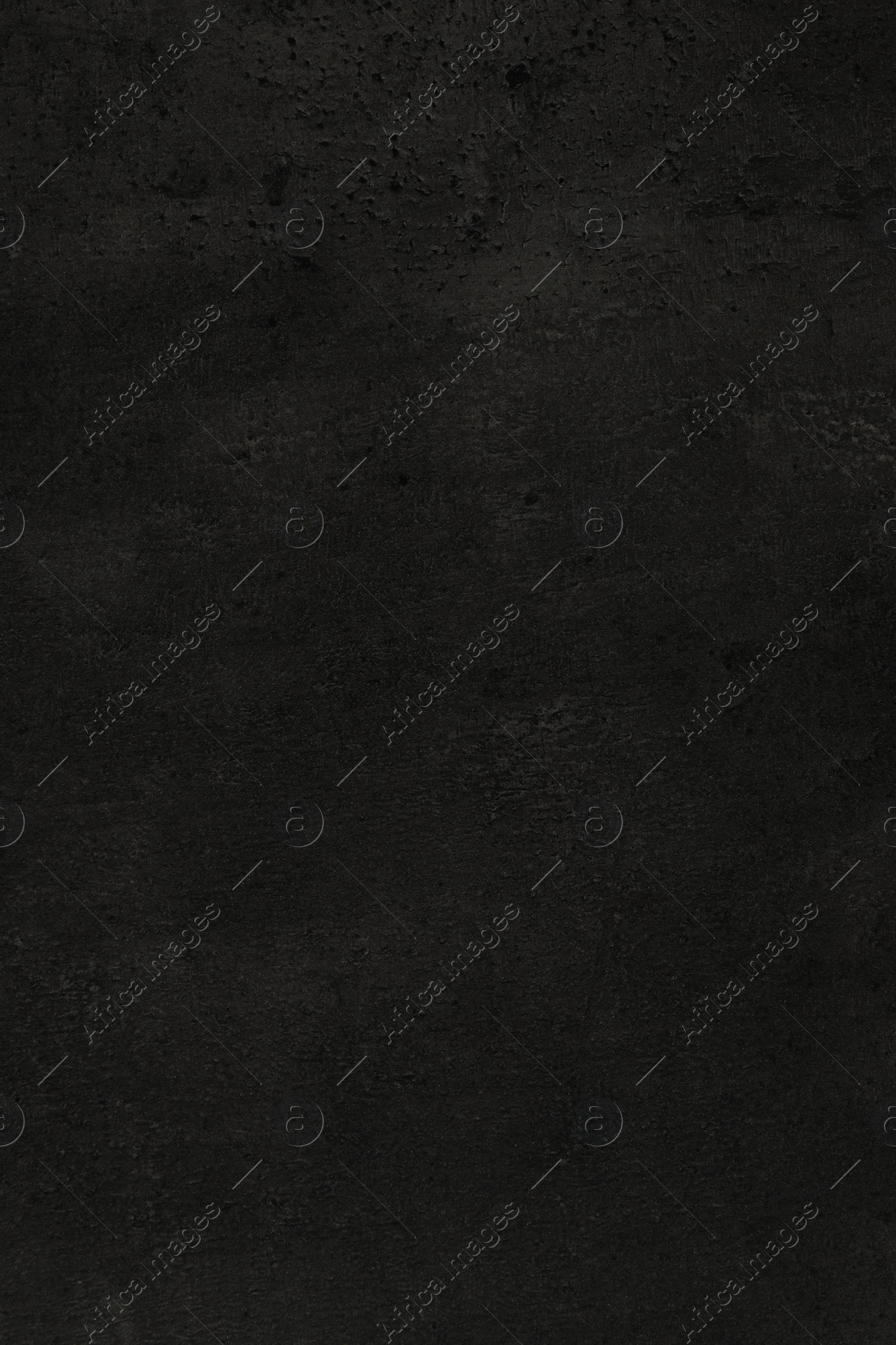 Photo of Texture of black stone surface as background, closeup