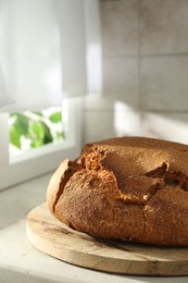 Photo of Freshly baked sourdough bread on light table