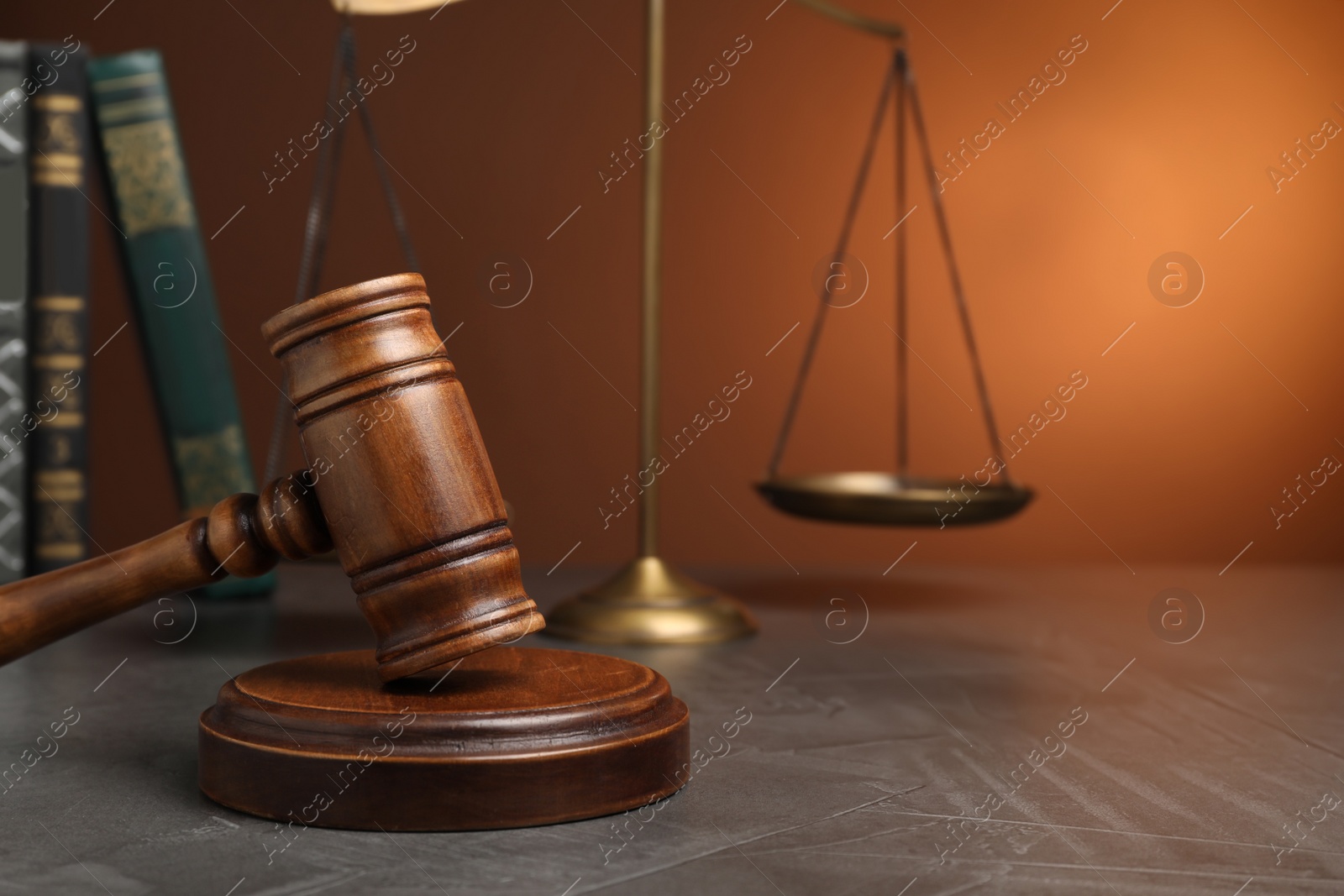 Photo of Wooden gavel on grey table, space for text. Law concept