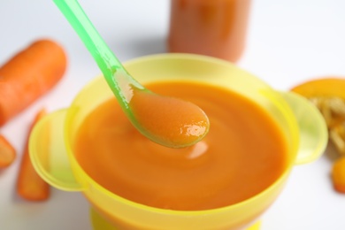 Photo of Healthy baby food and ingredients on white background, closeup