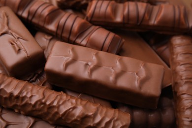 Many different tasty chocolate bars as background, closeup