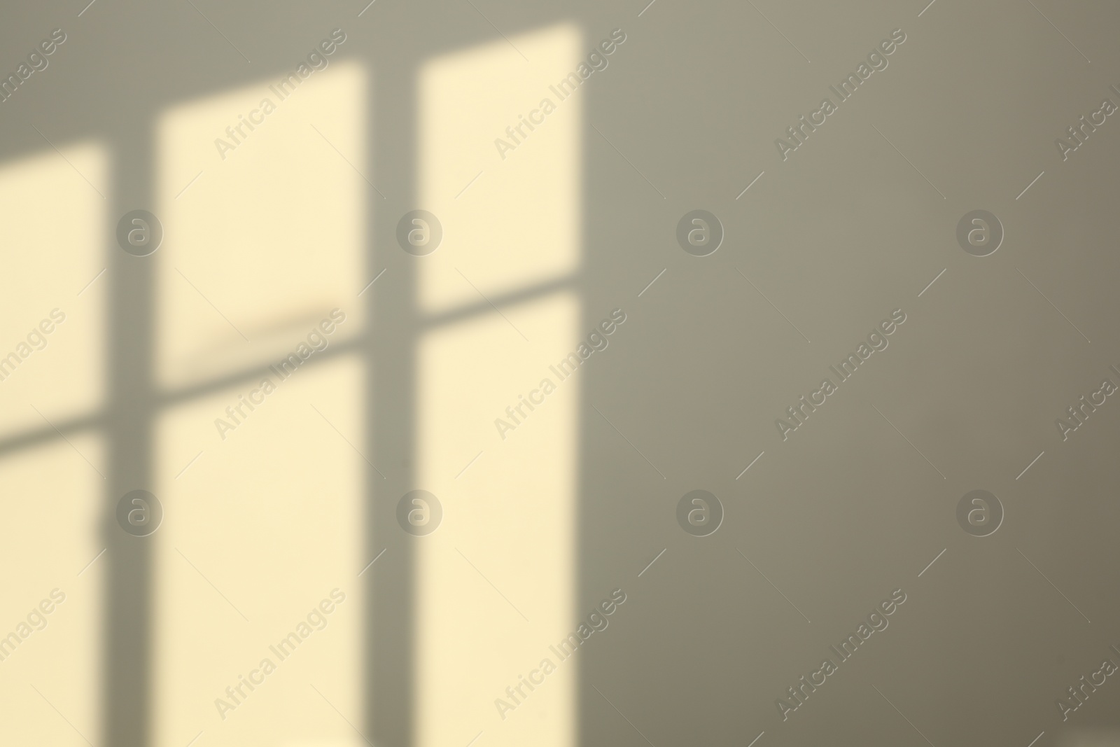 Photo of Light and shadows from window on wall indoors