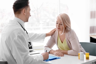 Photo of Male doctor consulting patient in clinic