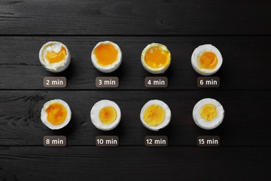 Different readiness stages of boiled chicken eggs on black wooden table, flat lay