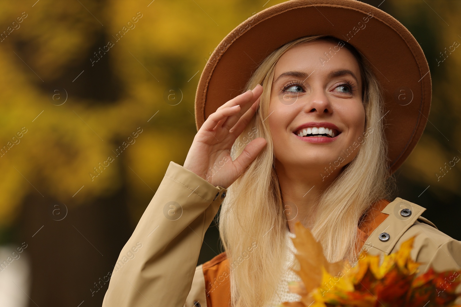 Photo of Portrait of happy woman with autumn leaves outdoors