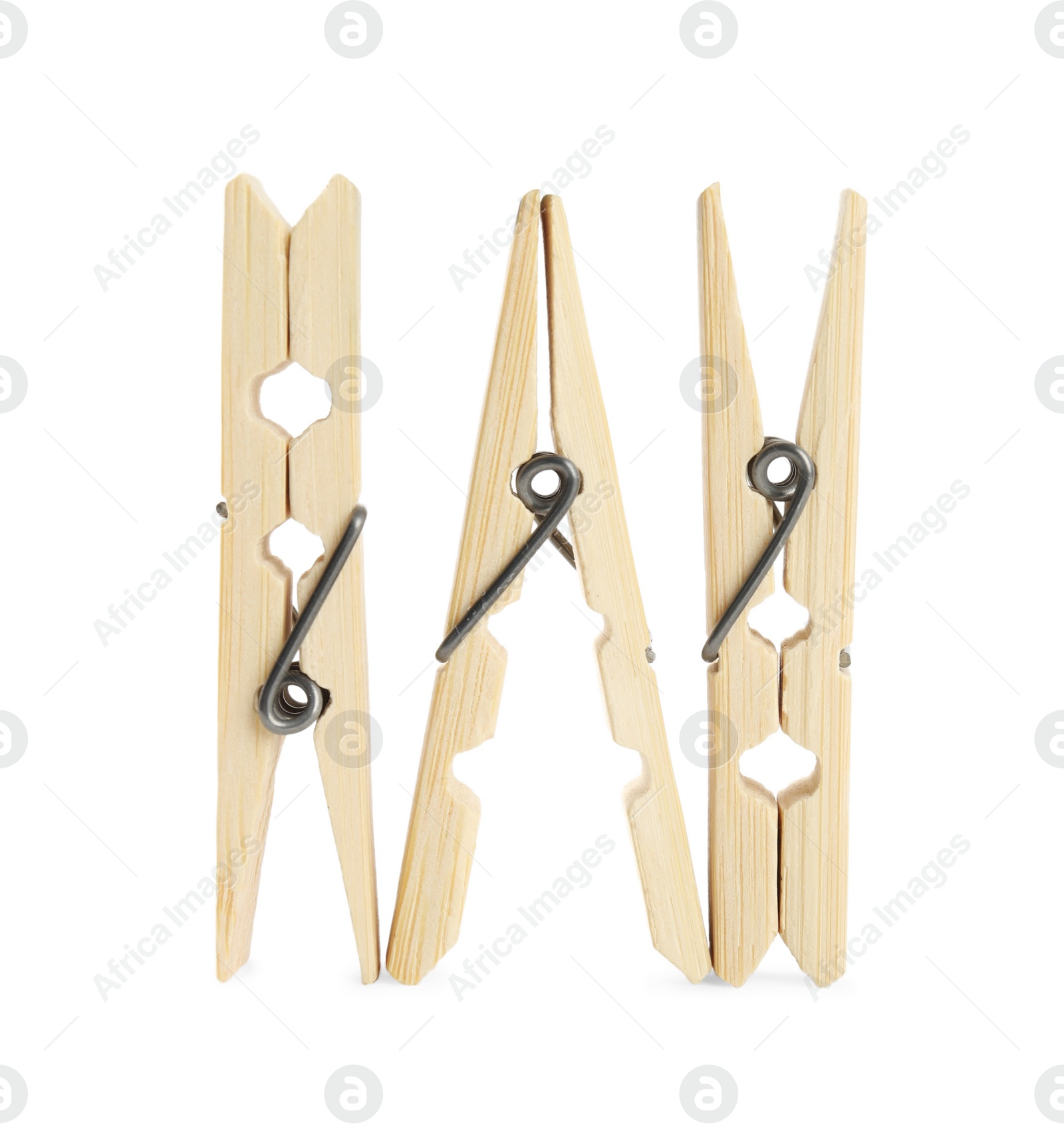 Photo of Three classic wooden clothespins on white background