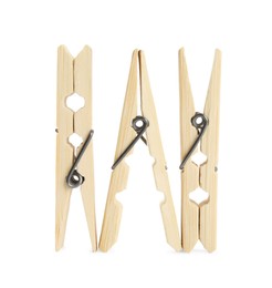 Three classic wooden clothespins on white background