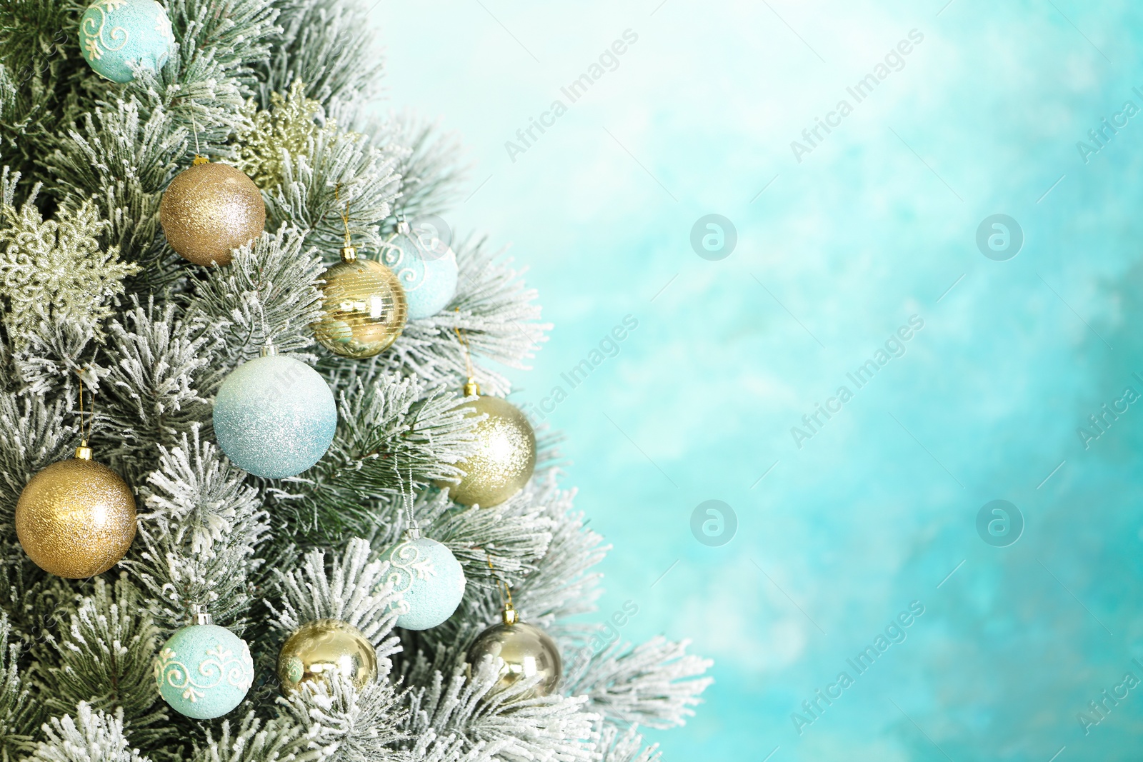 Photo of Beautiful Christmas tree with decor against light blue background. Space for text