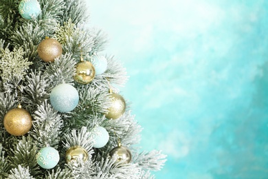 Photo of Beautiful Christmas tree with decor against light blue background. Space for text