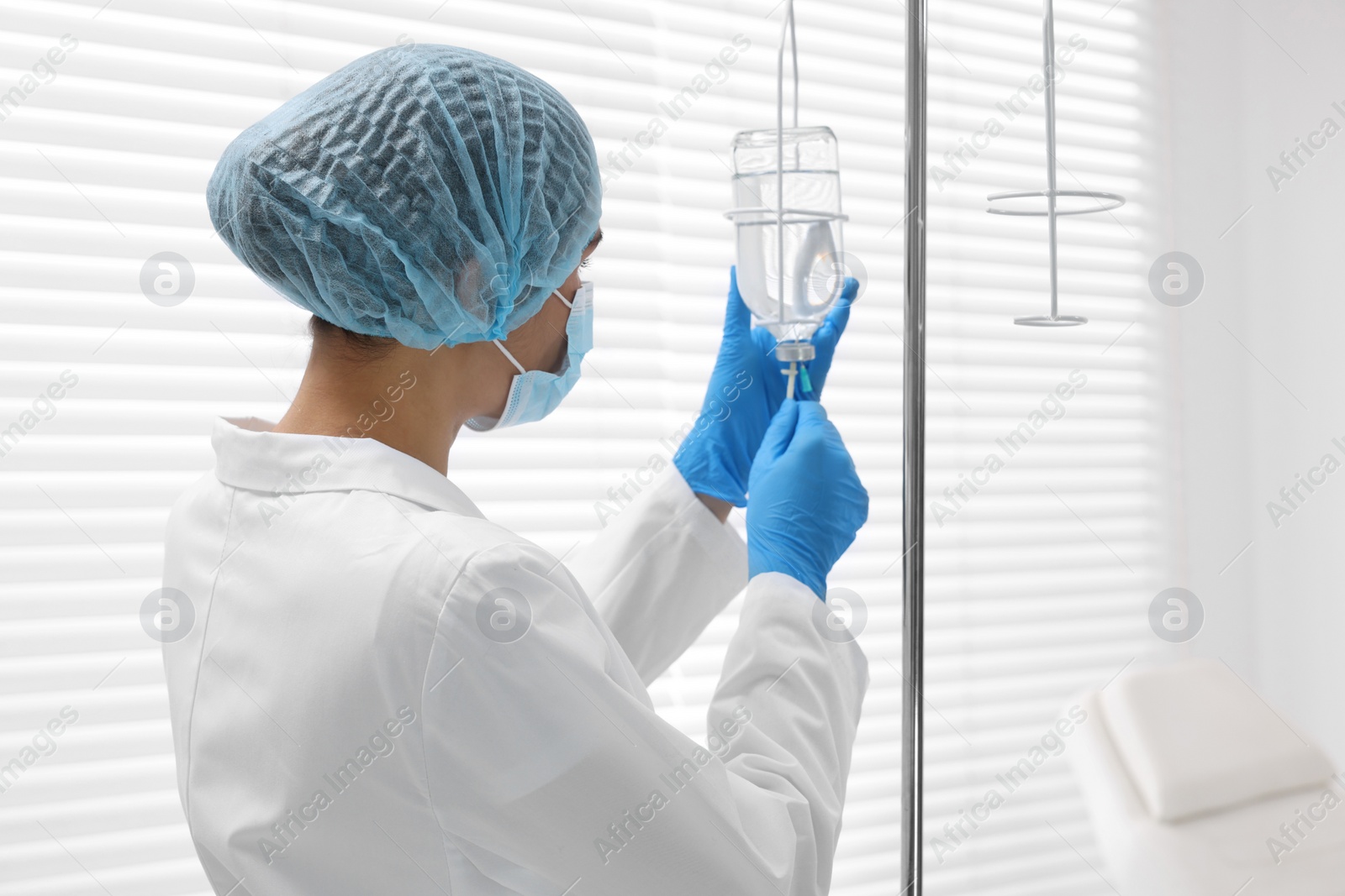 Photo of Nurse setting up IV drip in hospital