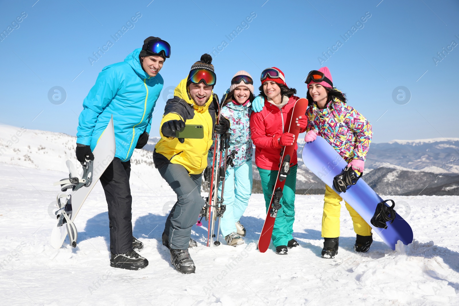 Photo of Group of friends taking selfie outdoors. Winter vacation