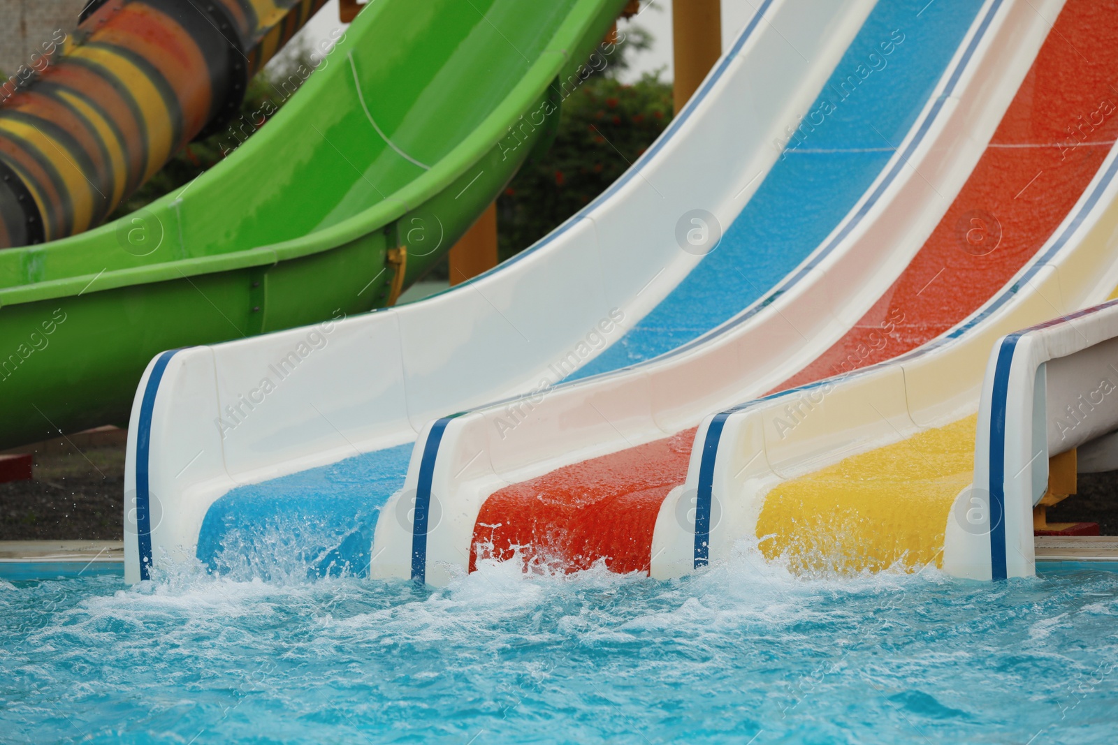 Photo of Colorful slides near swimming pool in water park