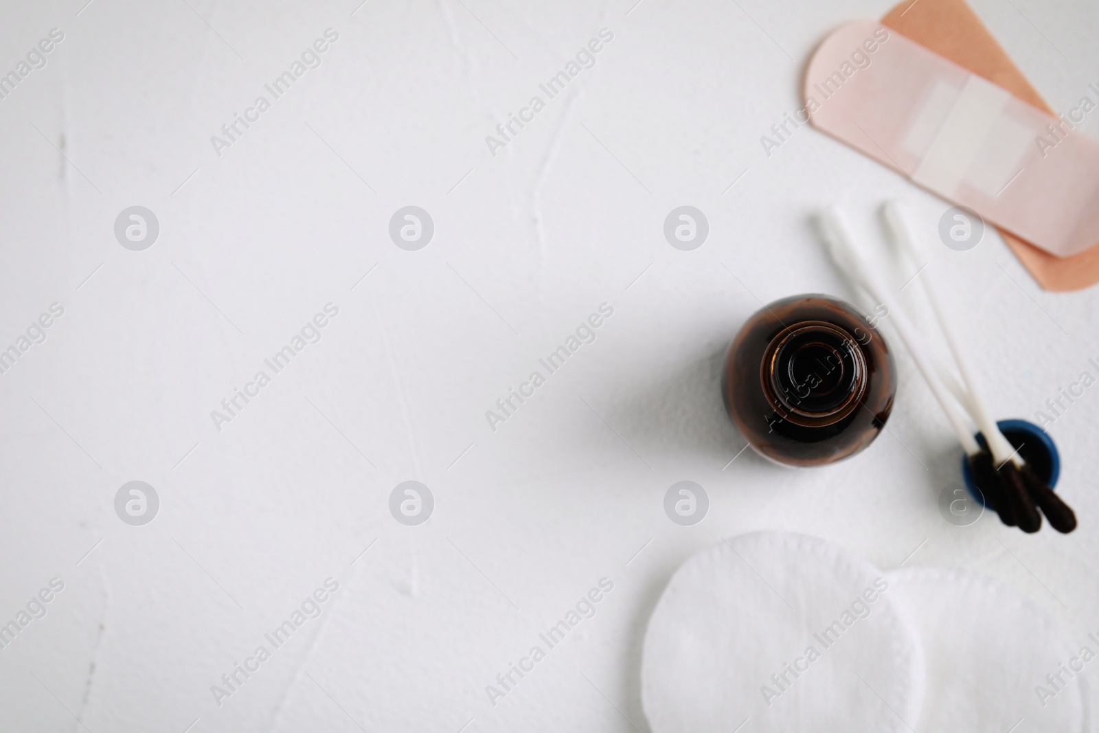 Photo of Flat lay composition with bottle of medical iodine on white table. Space for text