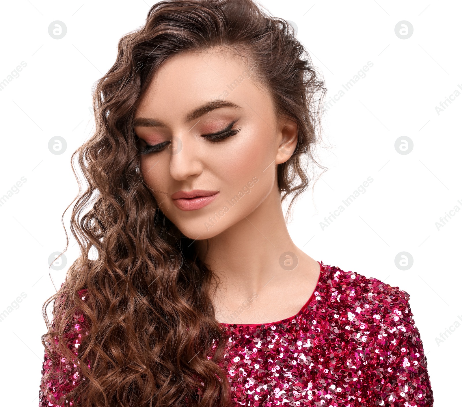 Photo of Beautiful young woman with long curly brown hair in pink sequin dress on white background