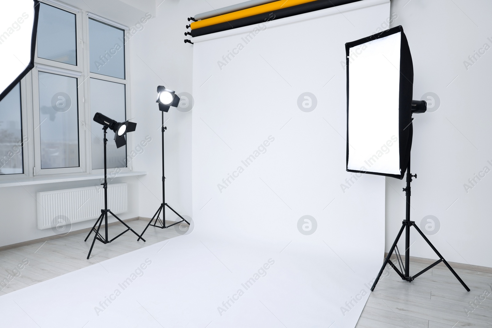 Photo of Interior of modern photo studio with professional lighting equipment